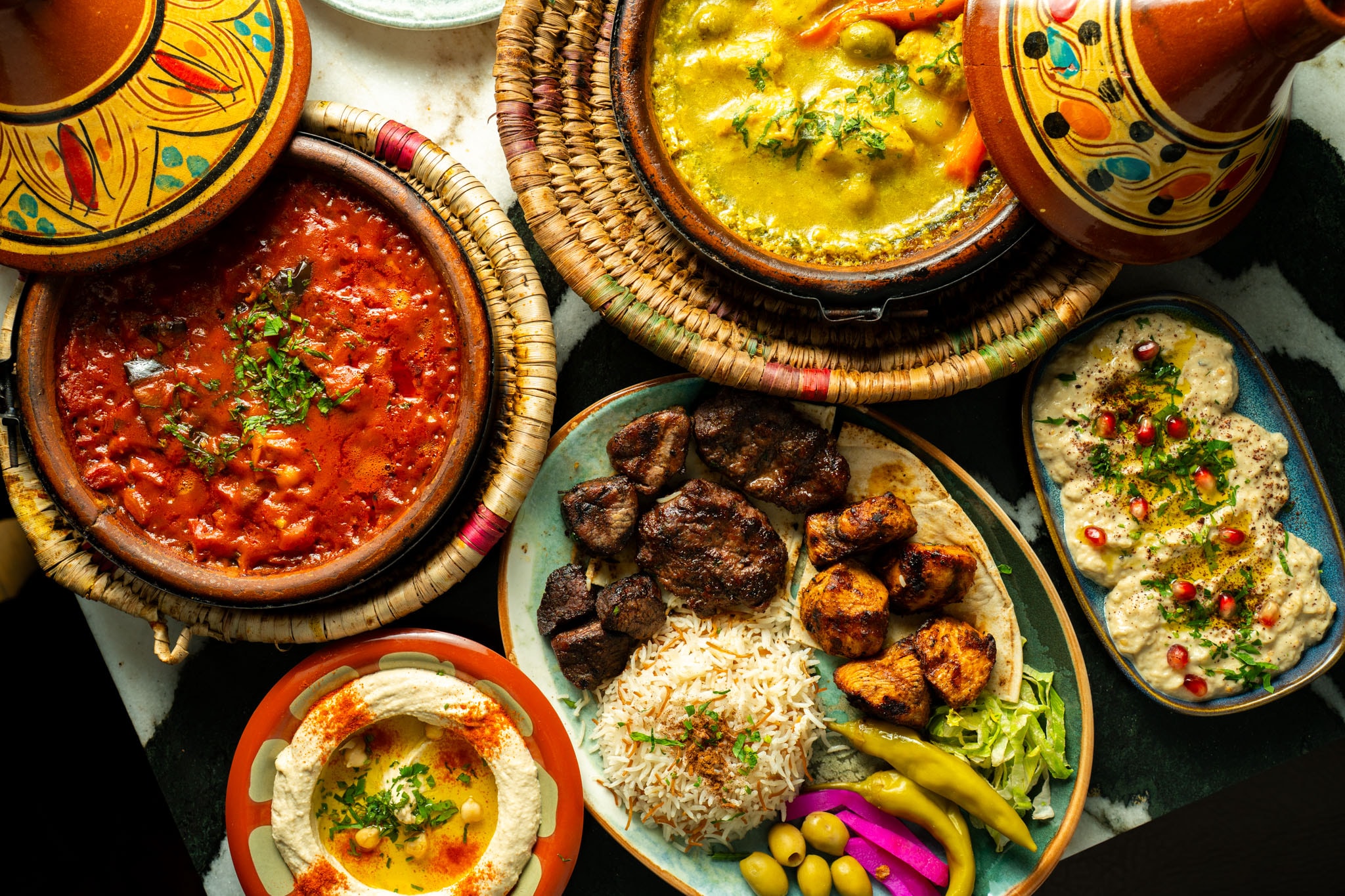 Moroccan and Lebanese feast spread with tagines, hummus and grilled meats at Leila